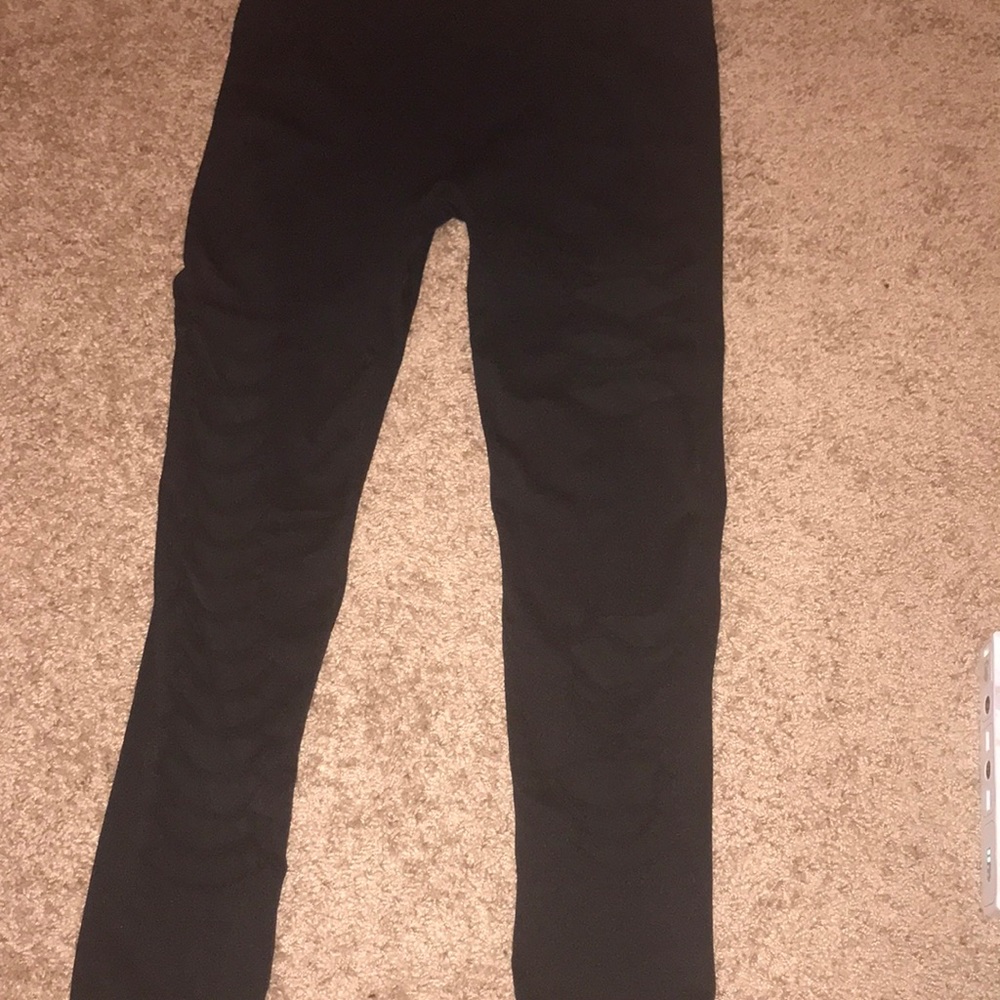 Black stretchy leggings with mesh rips.